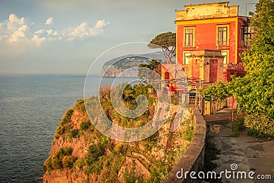 Sorrento cityscape above cliffs at golden sunset, Gulf of Naples, Southern Italy Stock Photo