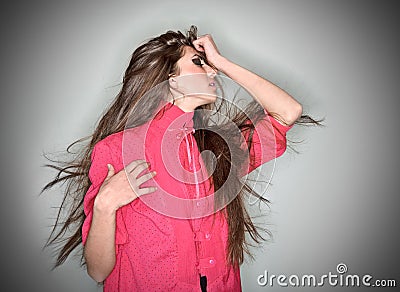 Sorrowful brunette woman dressed in pink blouse Stock Photo
