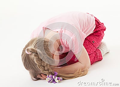 Sorrowful little girl on the floor Stock Photo