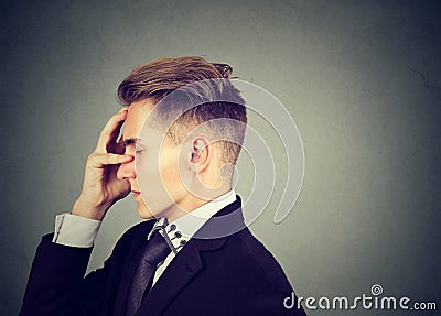 Sorrowful sad man thoughtful with worried face expression Stock Photo
