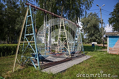 Children`s swing in a city park in the city of Sortavala in the Republic of Karelia in Russia Editorial Stock Photo