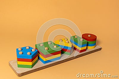 Sorter on neutral background. Multicolored logic sorter close up. Wooden educational logic toy for kid's. Montessori Stock Photo