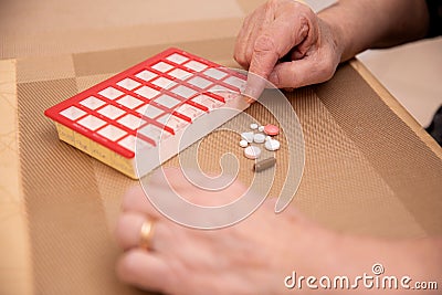 Elderly Hands Sorting Pills Stock Photo