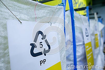 Sorting recyclables. The sorted polypropylene PP plastic, is placed in a container with the appropriate marking Stock Photo