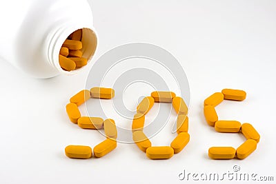 Pills forming word SOS Stock Photo