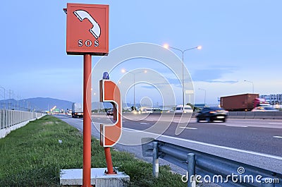 SOS sign and emergency telephone on the road Stock Photo