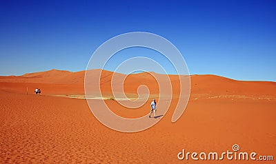 Onage sand dunes in Namibian desert with people walking across the sand Editorial Stock Photo