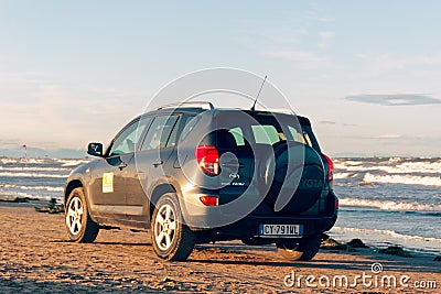 Sottomarina, Italy August 26, 2018: car drives along the city beach. Editorial Stock Photo