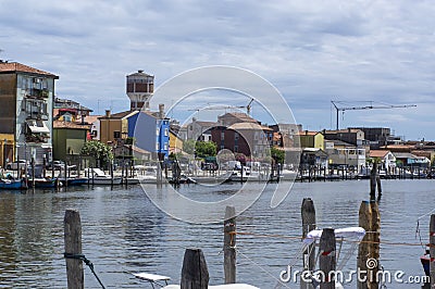 Sottomarina, ITALY - June 10, 2022: Pictoresque streets of old town Sottomarina, colorful buldings, blue house reservoir tower Editorial Stock Photo