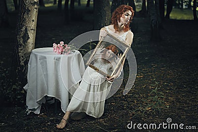 Soul of a woman trapped inside a mirror Stock Photo