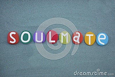 Soulmate word composed with multi colored stone letters over green sand Stock Photo