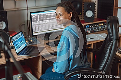 Sound engineer, music composer, anchorwoman, radio presenter, artist at work in the sound and audio recording studio Stock Photo