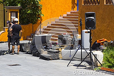 Sound engineers preparing for a street concert and setting up an amplification system in a street in Playa de las Americas Tenerif Editorial Stock Photo
