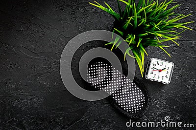 Sound sleep concept. Sleep mask, plant, alarm clock on black background top view copyspace Stock Photo