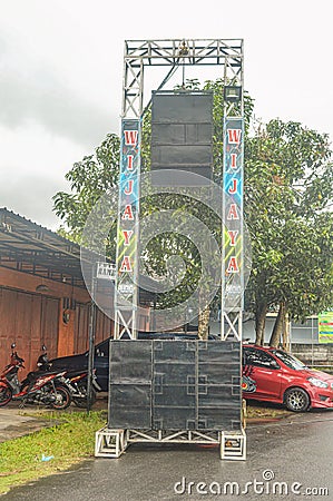 a sound system package assembled on iron sound rigging consisting of line array speakers and a large sub woofer Editorial Stock Photo