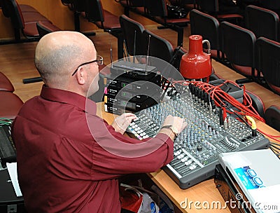 The sound technician works on the mixing console Editorial Stock Photo