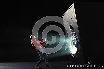 Powerful sound wave with funny sound speaker and screaming man. Stock Photo