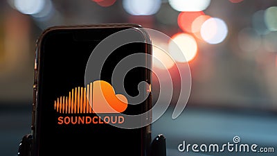 Soundcloud app on a smartphone in a car Editorial Stock Photo