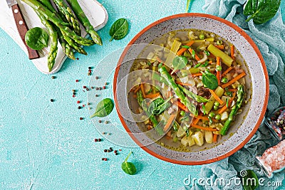 Soup with beef, asparagus, green peas, carrots and celery Stock Photo