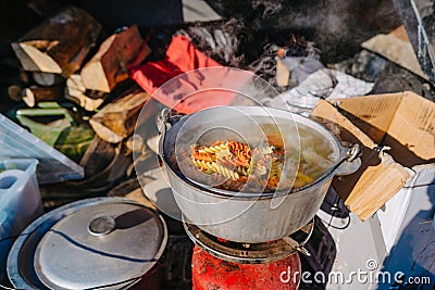 Soup Boiling on burner, cooking food outdoor on gas jet Stock Photo