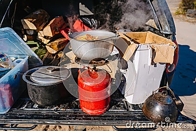 Soup Boiling on burner, cooking food outdoor on gas jet Stock Photo