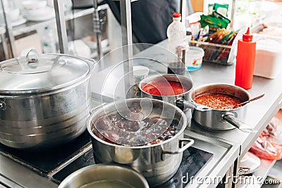 Soup boiling in pan at restaurant kitchen Stock Photo