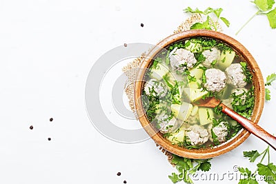 Soup with chicken meatballs, white background, top view Stock Photo