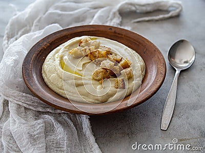 Soup of Jerusalem artichoke and croutons. Vegan cream soup in ceramic bowl. Close up. Copy space. Stock Photo