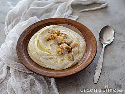 Soup of Jerusalem artichoke and croutons. Vegan cream soup in ceramic bowl. Close up. Copy space. Stock Photo