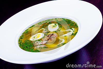 Soup with meat, quail eggs and noodles Stock Photo