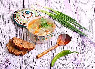 Soup with pelmeni, a potato, carrots submitted with a green onio Stock Photo