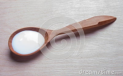 Sour cream in wooden spoon . sauce, yogurt, kefir, milk Stock Photo