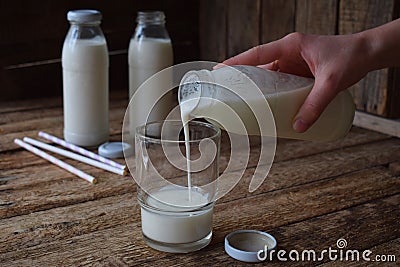 Sour-dairy drink or yoghurt in bottle that come from the kefir grains and milk on wooden background. Photographed with natural lig Stock Photo