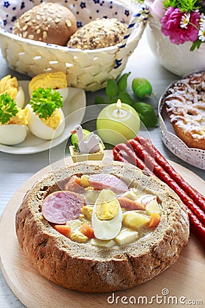 The sour rye soup inside loaf of bread. Easter breakfast table Stock Photo
