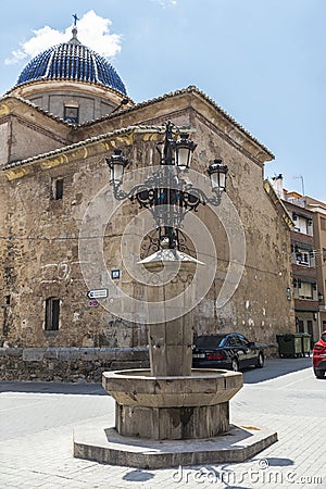 Source and lamp post in the village square, Spain Editorial Stock Photo