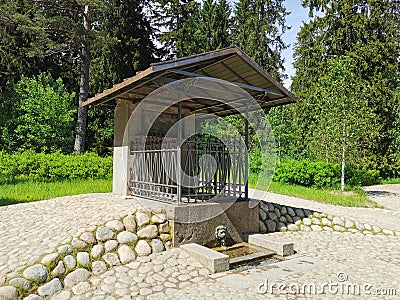 The source of the narcissus from the lion`s mouth in the rocky natural park of Monrepos in the city of Vyborg on a clear summer Editorial Stock Photo