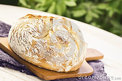 Sourdough Boule or Loaf of Bread on Cutting Board Stock Photo