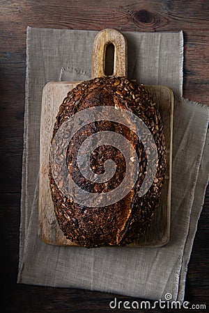 Sourdough bread on cutting boarding, with linen tablecloth Stock Photo