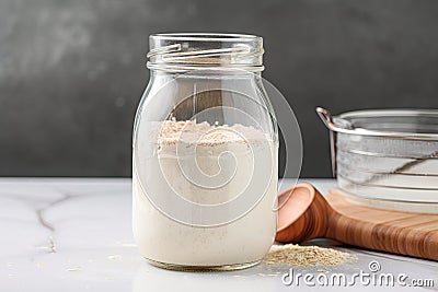sourdough starter in glass jar, ready for use and feeding Stock Photo
