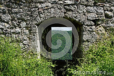 Look through castle ruin gate to forest Stock Photo