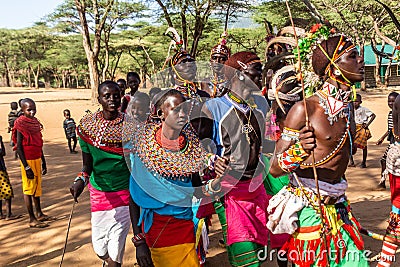 SOUTH HORR, KENYA - FEBRUARY 12, 2020: Group of Samburu tribe young men and women dancing wearing colorful headpieces Editorial Stock Photo