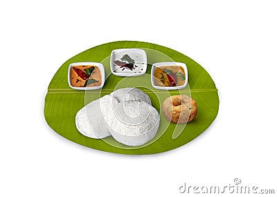South Indian breakfast idly vada, vadai ,with coconut chutney, red chutney, and sambar served on banana leaf Stock Photo