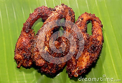 Carp fish fried slices on a banana leaf. Stock Photo