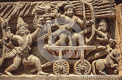 South Indian temple relief with battle scene. warriors with bow and arrows from 12th century, Halebidu, India Stock Photo