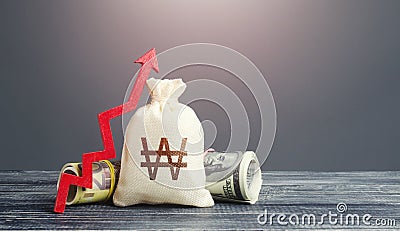 South Korean Won money bag and red arrow up. Growth of economy and increase of investment attractiveness. Stable currency. Stock Photo