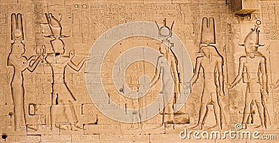 The south wall of the temple of Hathor at Dendera with lion-headed waterspouts. Cleopatra and her son Caesarian on the left side Stock Photo