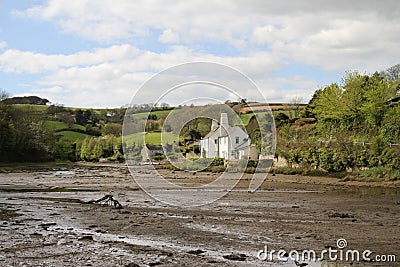 Southpool creek with houses and hilly fields in Devon Editorial Stock Photo