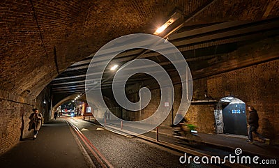 Southwark, London, UK: Bermondsey Street passing through a road tunnel with cyclist and pedestrians Editorial Stock Photo