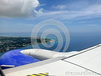Southwest airplane wing flying above the Cayman Islands on a bright blue sky sunny day Stock Photo