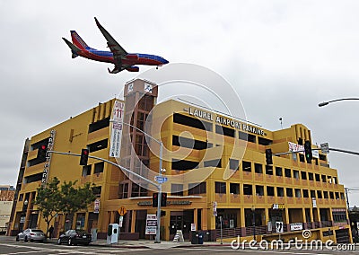 A Southwest Jet on Low Approach Over Laurel Parking Garage Editorial Stock Photo